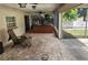 Covered patio with tile flooring, ceiling fan, and seating area at 8209 Chaucer Dr, Weeki Wachee, FL 34607
