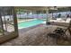 Screened-in patio with a view of the in-ground pool at 8209 Chaucer Dr, Weeki Wachee, FL 34607