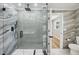 The luxurious bathroom features a glass-enclosed shower with gray tiling and marble wall accents at 911 S Florida Ave, Tarpon Springs, FL 34689