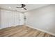 Bedroom featuring wood-look floors, white trim, and ample closet space at 911 S Florida Ave, Tarpon Springs, FL 34689