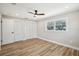 Bedroom with wood-look flooring, a ceiling fan, and a view of the backyard at 911 S Florida Ave, Tarpon Springs, FL 34689