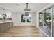 Dining area featuring modern light fixture, hardwood floors, and slider leading to the screened-in back patio at 911 S Florida Ave, Tarpon Springs, FL 34689