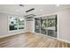 Bright dining area with wood floors, modern light fixture, and sliding glass doors to the outdoor patio at 911 S Florida Ave, Tarpon Springs, FL 34689