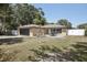 The home's exterior offers a well-manicured lawn, cozy patio seating and an attached garage at 911 S Florida Ave, Tarpon Springs, FL 34689