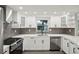 Bright kitchen showcasing white cabinetry, stainless appliances, and a garden window at 911 S Florida Ave, Tarpon Springs, FL 34689
