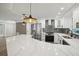 Bright, modern kitchen with an island, stainless steel appliances, and pendant lighting at 911 S Florida Ave, Tarpon Springs, FL 34689