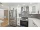 Well-equipped kitchen featuring modern stainless steel appliances and white cabinets at 911 S Florida Ave, Tarpon Springs, FL 34689
