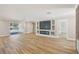 Bright living area with hardwood floors, leading to sliders overlooking the pool with sleek design at 911 S Florida Ave, Tarpon Springs, FL 34689