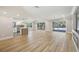 Bright, open living space with hardwood floors and sliders that lead to a screened in patio and pool at 911 S Florida Ave, Tarpon Springs, FL 34689