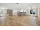 Open-concept living space with hardwood floors, stylish accents, and abundant natural light with kitchen view at 911 S Florida Ave, Tarpon Springs, FL 34689