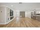 Spacious living area featuring hardwood floors, built-in entertainment center, and modern accent wall at 911 S Florida Ave, Tarpon Springs, FL 34689