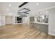 Spacious and open living area features hardwood floors, a modern island, and stylish light fixtures at 911 S Florida Ave, Tarpon Springs, FL 34689