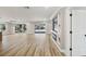 Spacious living room boasts hardwood floors, modern fixtures, and ample natural light. Sliders lead to screened-in pool at 911 S Florida Ave, Tarpon Springs, FL 34689