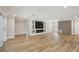 Large living room with hardwood floors, modern fixtures, built-in entertainment center, and lots of natural light at 911 S Florida Ave, Tarpon Springs, FL 34689