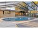Backyard featuring a screened-in pool and patio area at 911 S Florida Ave, Tarpon Springs, FL 34689