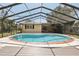 This sparkling screened pool and deck adjoin the home and offer an oasis for outdoor living at 911 S Florida Ave, Tarpon Springs, FL 34689