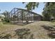 This home features a large screened pool enclosure with a view of the fenced back yard at 911 S Florida Ave, Tarpon Springs, FL 34689