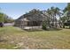 This home features a large screened pool enclosure with a view of the fenced back yard at 911 S Florida Ave, Tarpon Springs, FL 34689