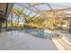 Large screened-in pool surrounded by trees at 911 S Florida Ave, Tarpon Springs, FL 34689