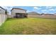 A beautiful backyard with green grass, a white fence, and an inviting screened-in patio area at 9640 Lemon Drop Loop, Ruskin, FL 33573