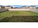 This spacious, fenced backyard features lush green grass, perfect for outdoor activities and gardening at 9640 Lemon Drop Loop, Ruskin, FL 33573