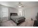 Cozy bedroom with a queen bed, ceiling fan, and a window providing natural light at 9640 Lemon Drop Loop, Ruskin, FL 33573