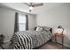 Comfortable bedroom with a window, neutral walls, and a ceiling fan for optimal comfort at 9640 Lemon Drop Loop, Ruskin, FL 33573