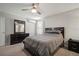 A spacious bedroom with a ceiling fan, dresser, and a comfortable bed at 9640 Lemon Drop Loop, Ruskin, FL 33573