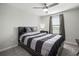 Modern bedroom featuring a comfortable bed, neutral-colored walls, and window with blinds at 9640 Lemon Drop Loop, Ruskin, FL 33573