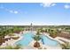 An inviting community pool with a slide and lush tropical landscaping offers a resort-like experience at 9640 Lemon Drop Loop, Ruskin, FL 33573