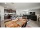 A dining room with a marble table and leather chairs connects to the kitchen and living area at 9640 Lemon Drop Loop, Ruskin, FL 33573