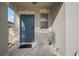 Close-up of the home's entryway showing a blue front door and covered porch at 9640 Lemon Drop Loop, Ruskin, FL 33573