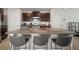Kitchen with an island, dark wood cabinets, stainless steel appliances, and a breakfast bar at 9640 Lemon Drop Loop, Ruskin, FL 33573