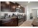 Kitchen features dark wood cabinets, stainless steel appliances, and granite counters at 9640 Lemon Drop Loop, Ruskin, FL 33573