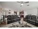 Bright living room featuring modern furniture, ceiling fan, and hardwood style floors adjacent to kitchen at 9640 Lemon Drop Loop, Ruskin, FL 33573