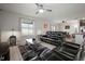 Living room with a leather sectional, modern rug, and views of the dining and kitchen areas at 9640 Lemon Drop Loop, Ruskin, FL 33573