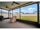 View of the screened patio, equipped with ceiling fans, overlooking the home's fenced yard at 9640 Lemon Drop Loop, Ruskin, FL 33573