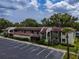 Aerial view showcases the building's architecture, parking, and surrounding landscape at 1100 East Bay Dr # 42, Largo, FL 33770