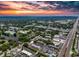 Sunset aerial view displays a vast suburban neighborhood with apartment complex near a major highway at 1100 East Bay Dr # 42, Largo, FL 33770