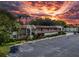 Aerial view of the community with lush greenery, ample parking, and colorful sunset at 1100 East Bay Dr # 42, Largo, FL 33770