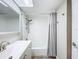 Clean bathroom with vanity, toilet, tub/shower combo, and a tile surround at 1100 East Bay Dr # 42, Largo, FL 33770