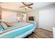 Bedroom with ceiling fan, closet, and ensuite bath offers a comfortable private retreat at 1100 East Bay Dr # 42, Largo, FL 33770