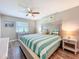 Bright bedroom featuring a comfortable queen bed, coastal decor, ceiling fan, and natural light at 1100 East Bay Dr # 42, Largo, FL 33770