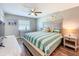 Cozy bedroom features coastal decor, ceiling fan, and a comfortable bed with stylish linens at 1100 East Bay Dr # 42, Largo, FL 33770