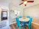 Dining area with a blue round dining table and stylish chairs creating a welcoming atmosphere at 1100 East Bay Dr # 42, Largo, FL 33770