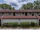 Exterior view of the condo featuring well-maintained landscaping and a shared outdoor space at 1100 East Bay Dr # 42, Largo, FL 33770