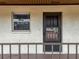A close-up of the front door with a small window and a railing in front of the entrance at 1100 East Bay Dr # 42, Largo, FL 33770