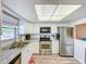 Kitchen boasts white cabinets, stainless appliances, and granite countertops for a modern touch at 1100 East Bay Dr # 42, Largo, FL 33770
