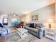 Bright living room with gray sofa, nautical decor, and adjacent dining area offers a relaxing space at 1100 East Bay Dr # 42, Largo, FL 33770