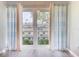 Bright sitting area with beach-themed curtains, and a view of the surrounding buildings at 1100 East Bay Dr # 42, Largo, FL 33770